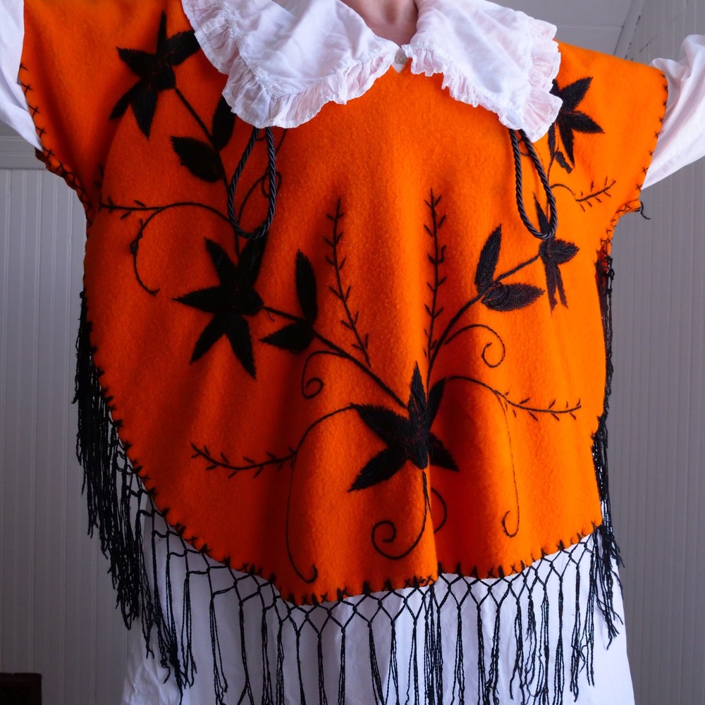 Fun vintage 1950s bright orange wool poncho with black floral embroidery